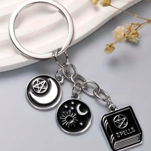 Black enamel spell book sun moon Keychain witchy